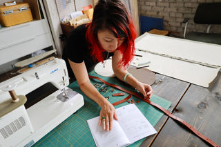 bag maker using a klum house canvas bag sewing pattern to make bags.